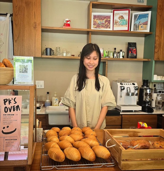 PK, the founder of PK's Oven, a passionate baker who transitioned from academia to pursue their love of artisanal bread making